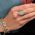 Pointed, flat, low profile blackened diamond and gold ring.