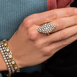 Pointed, flat, low profile blackened diamond and gold ring.