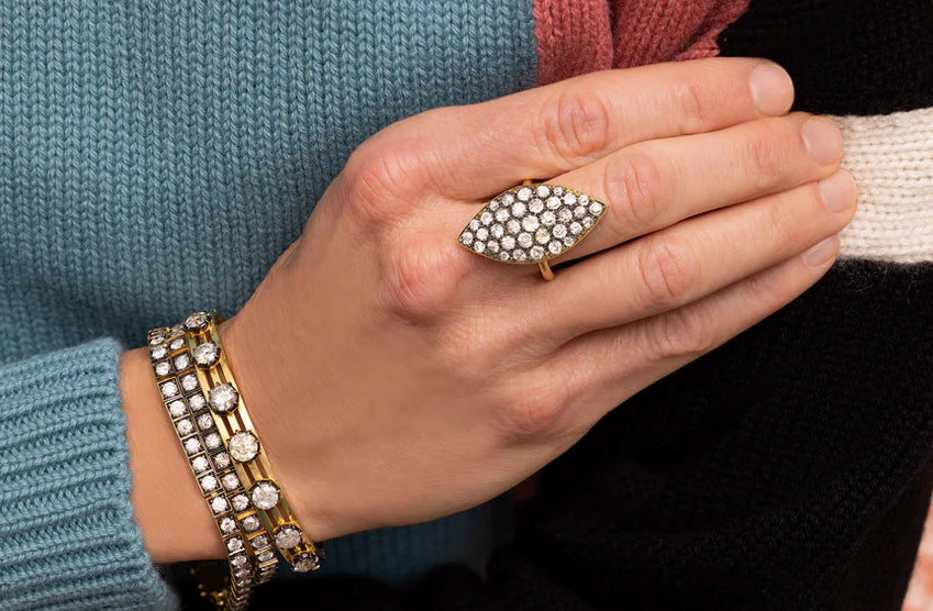 Pointed, flat, low profile blackened diamond and gold ring.