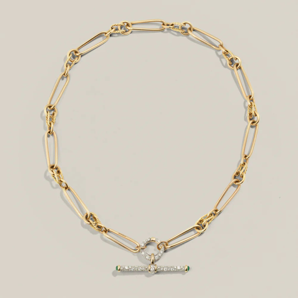 A product photograph showing how the twisted link gold women's chain can be styled with a diamond connect and vintage inspired t bar pendant.
