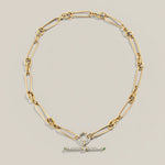 A product photograph showing how the twisted link gold women's chain can be styled with a diamond connect and vintage inspired t bar pendant.