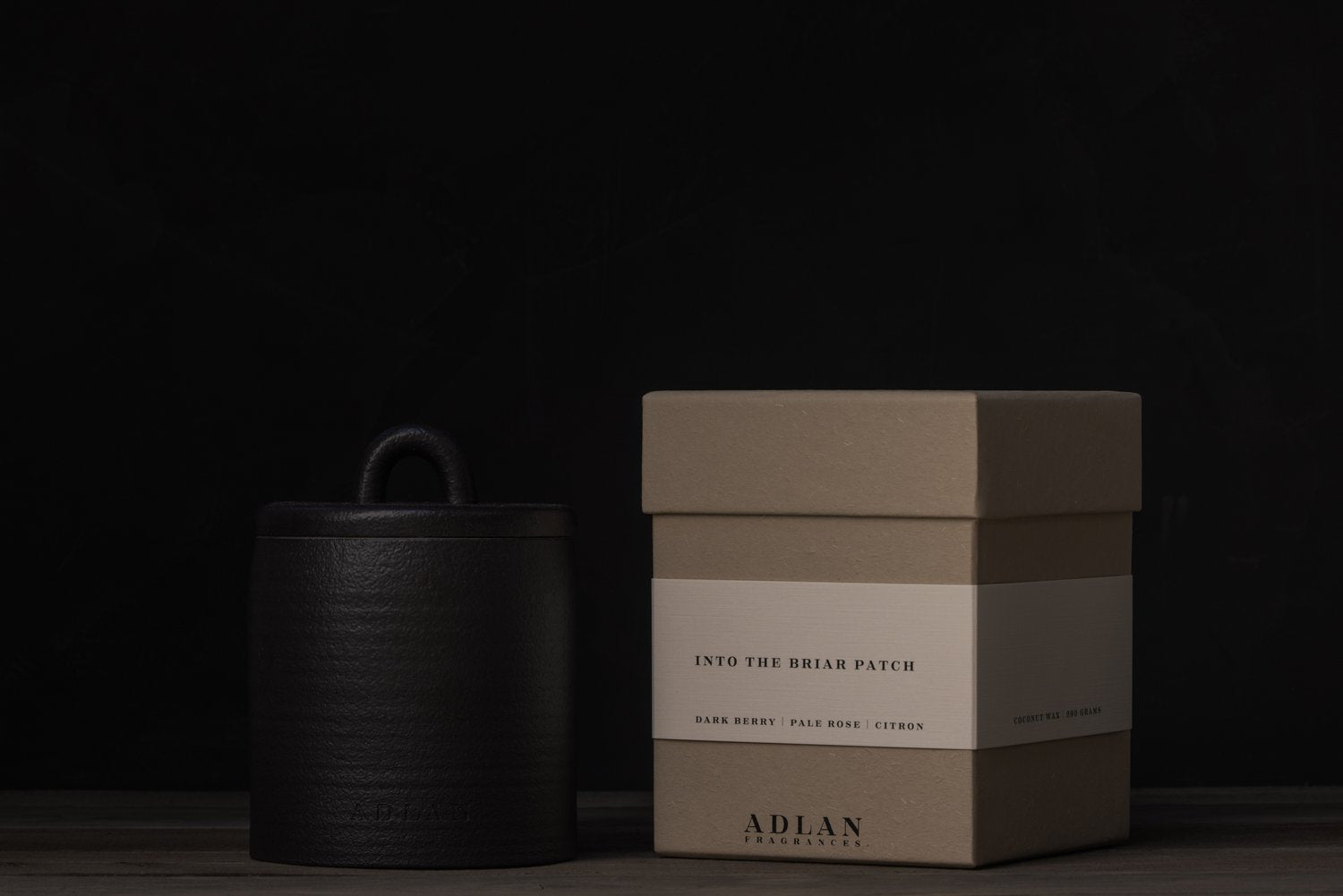 chic black ceramic vessel holding a berries, rose, citron scented luxury coconut wax candle with a beautiful, sustainable paper gift box.